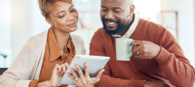 Middle-aged couple looking at tablet