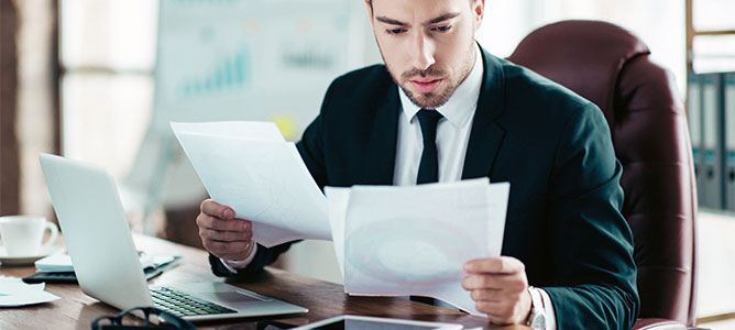 Man reviewing documents at desk