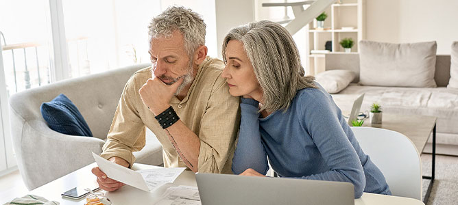 Worried couple reviewing documents