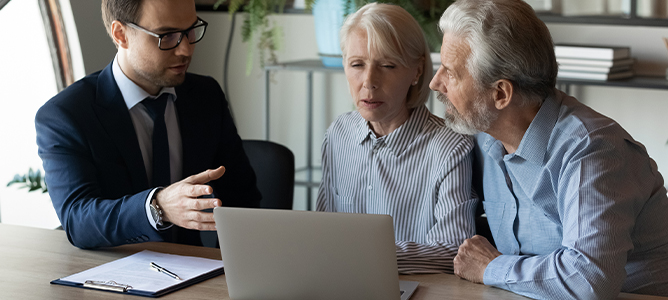 Senior couple consulting with financial professional