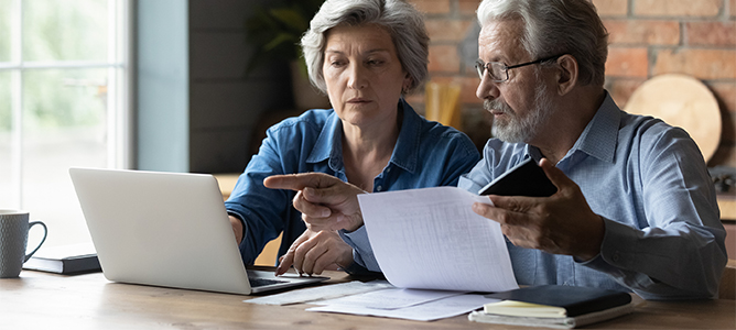 Senior couple reviewing paperwork