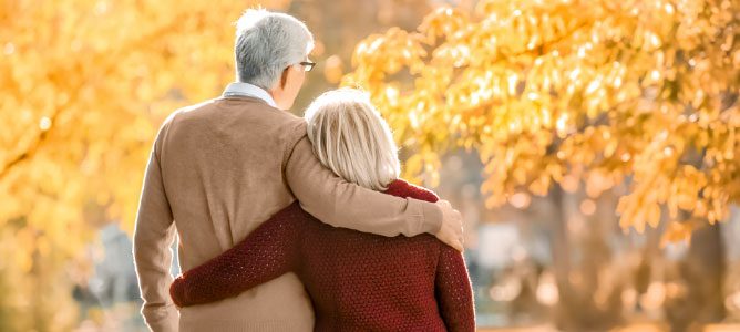 Senior couple looking at fall foliage