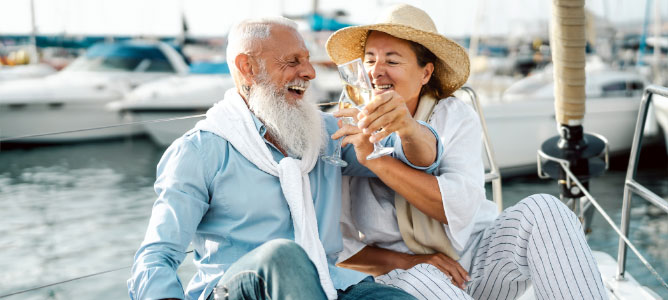 Retired couple toasting champagne on yacht