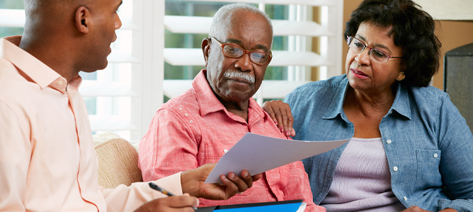 Senior couple meeting with financial professional at home
