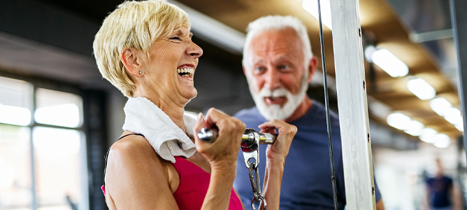 Active senior couple working out in the gym