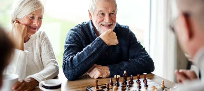Senior group of friends playing chess