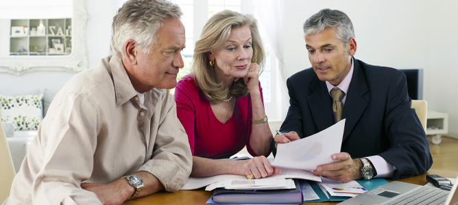 Senior couple meeting with financial professional at home