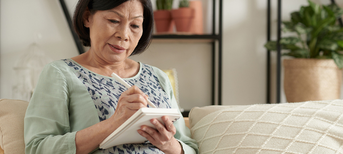 Senior woman writing in journal