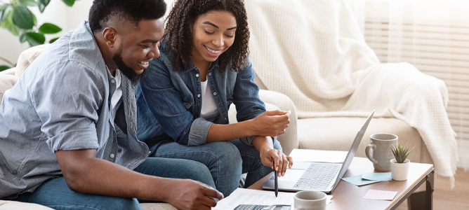 Happy millenial couple discussing financial planning