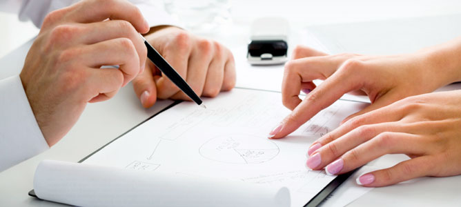 Hands Reviewing Diagram
